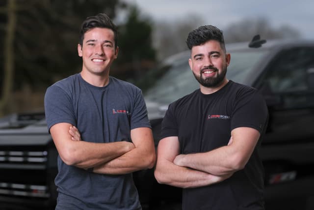 The LiningWorks crew in front of their service trucks.