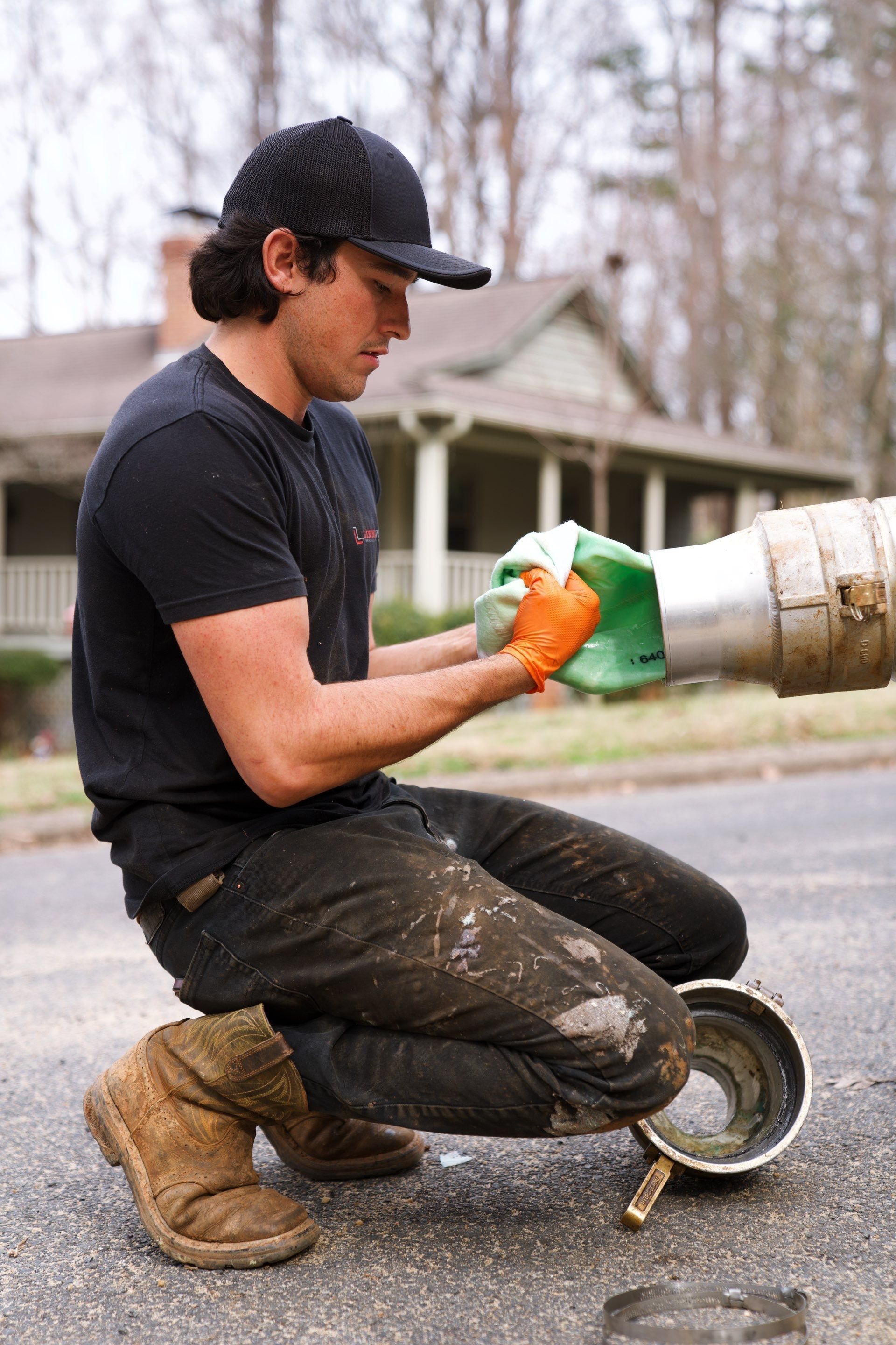 LiningWorks technician preparing pipe coupling equipment during a trenchless sewer repair