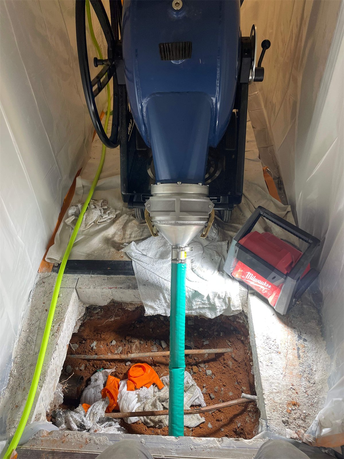 LiningWorks using the CIPP inversion method to line a damaged sewer pipe from an access pit in Winston-Salem, NC.