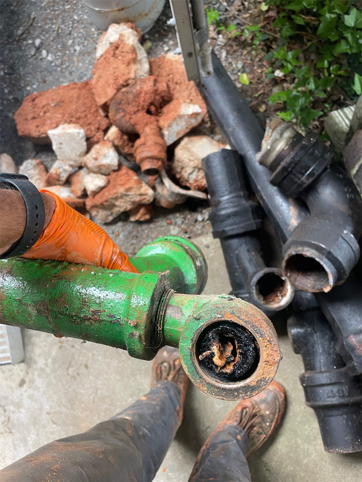Heavily clogged cast iron pipe inspected by LiningWorks: the buildup that signals a failing vertical stack.