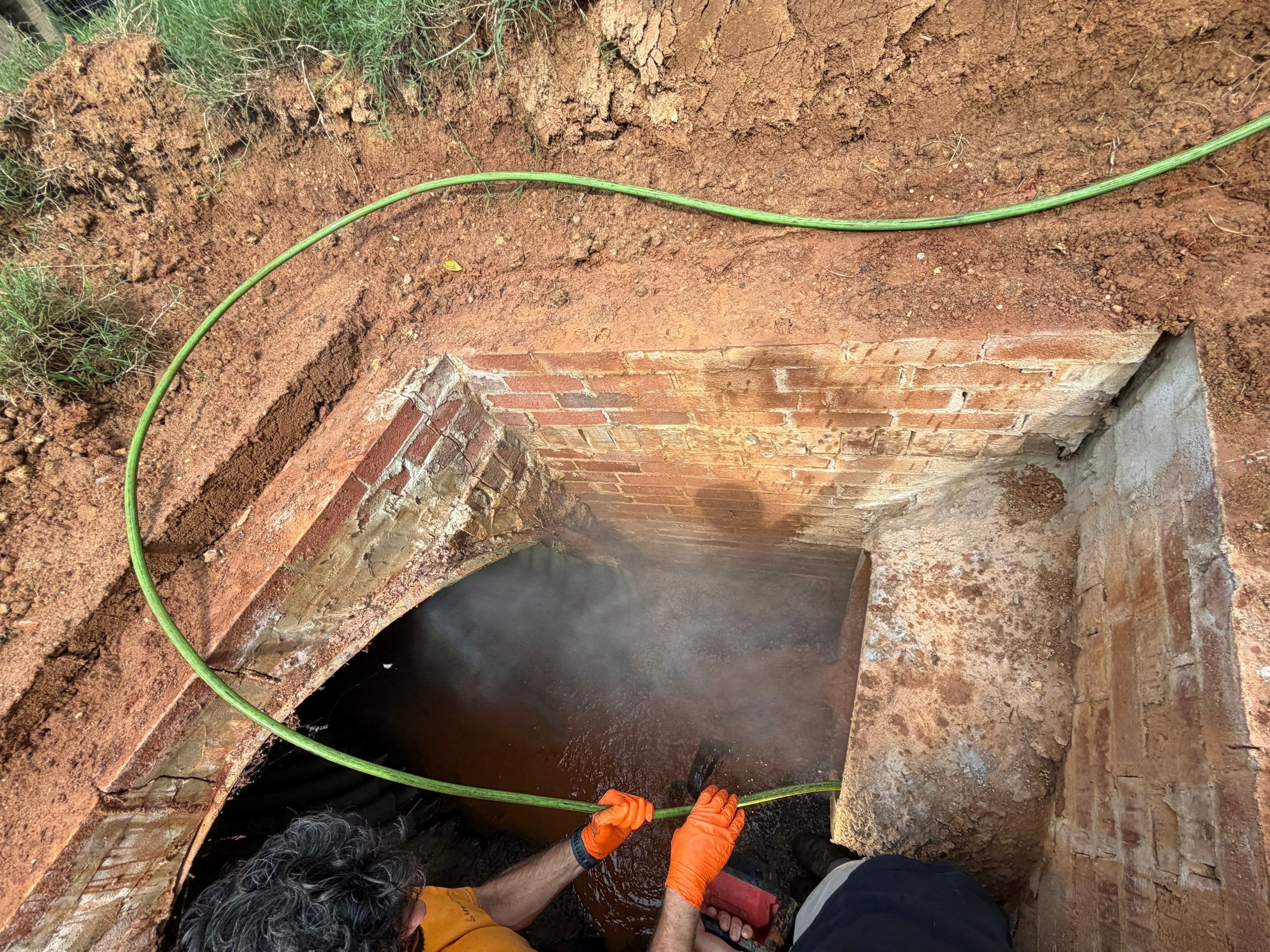 Commercial storm drain pipe deteriorated to the point of causing surface flooding.