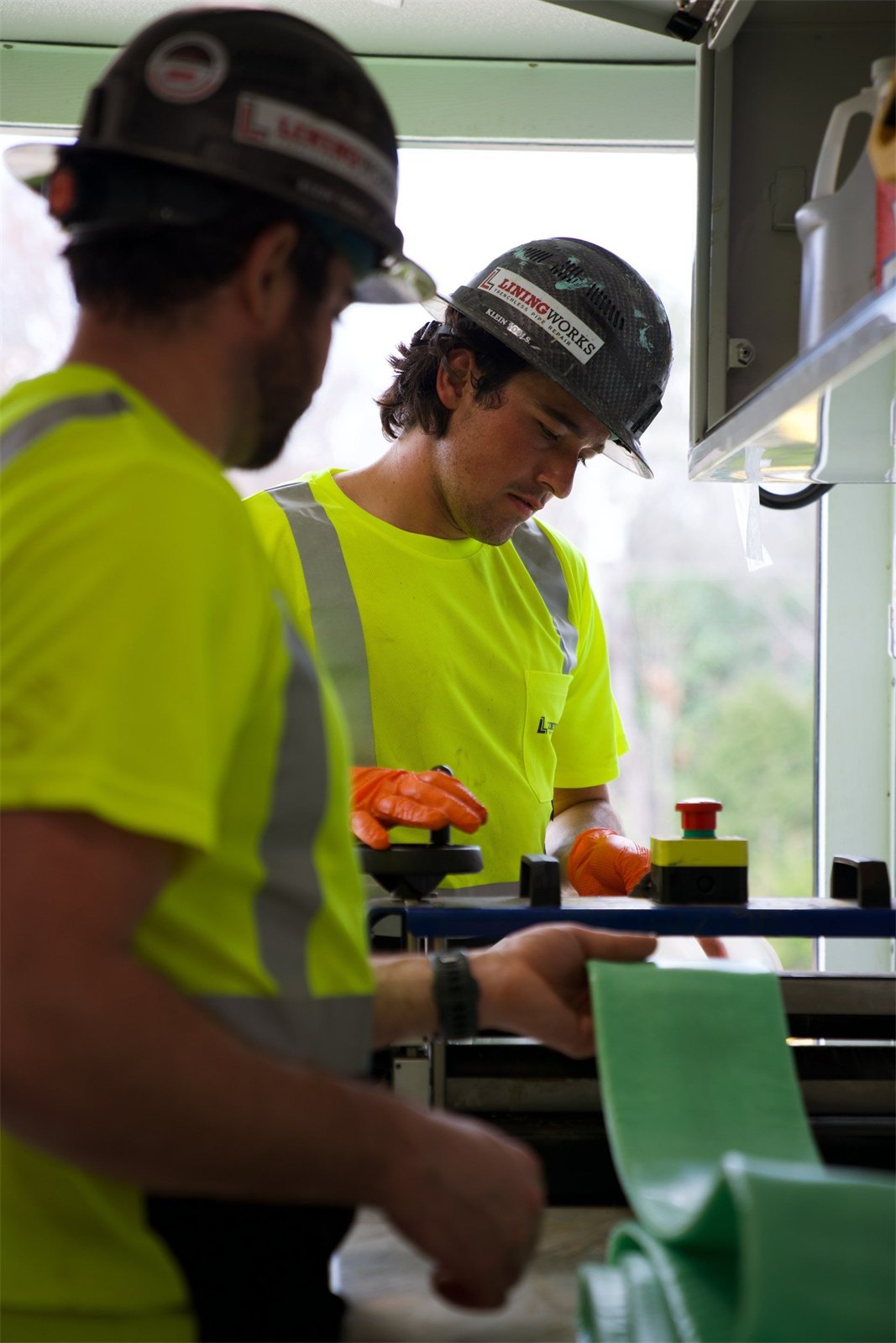 LiningWorks technicians preparing a green cured-in-place liner for a CIPP Pipe Lining job.