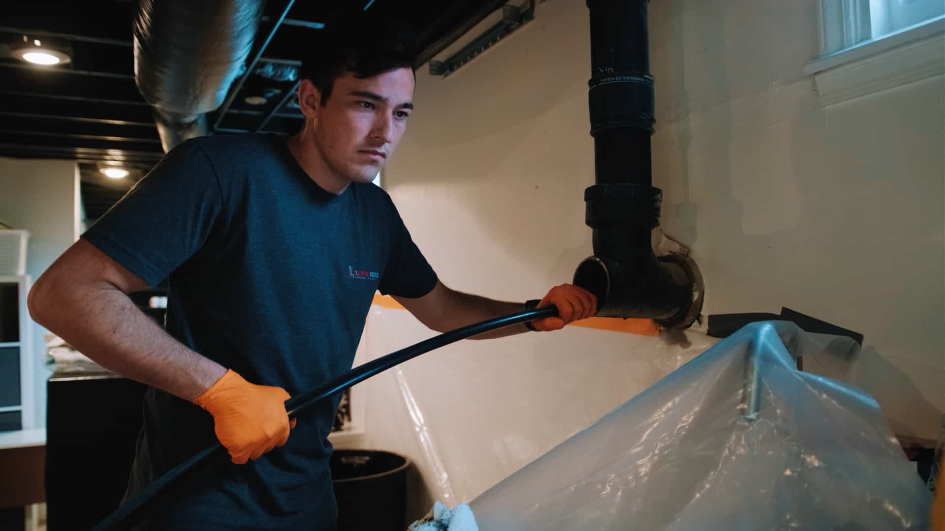 LiningWorks technician installing pipe liner in a basement.
