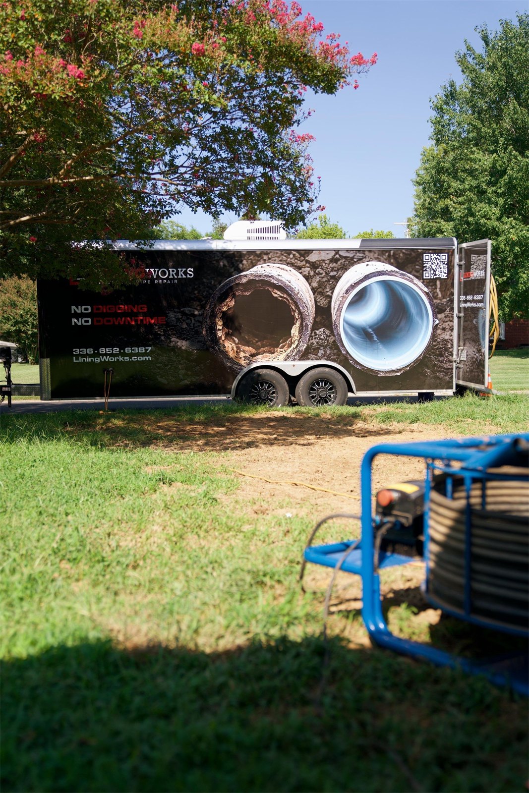 LiningWorks branded trailer displaying CIPP pipe lining results at a job site in Graham, NC.