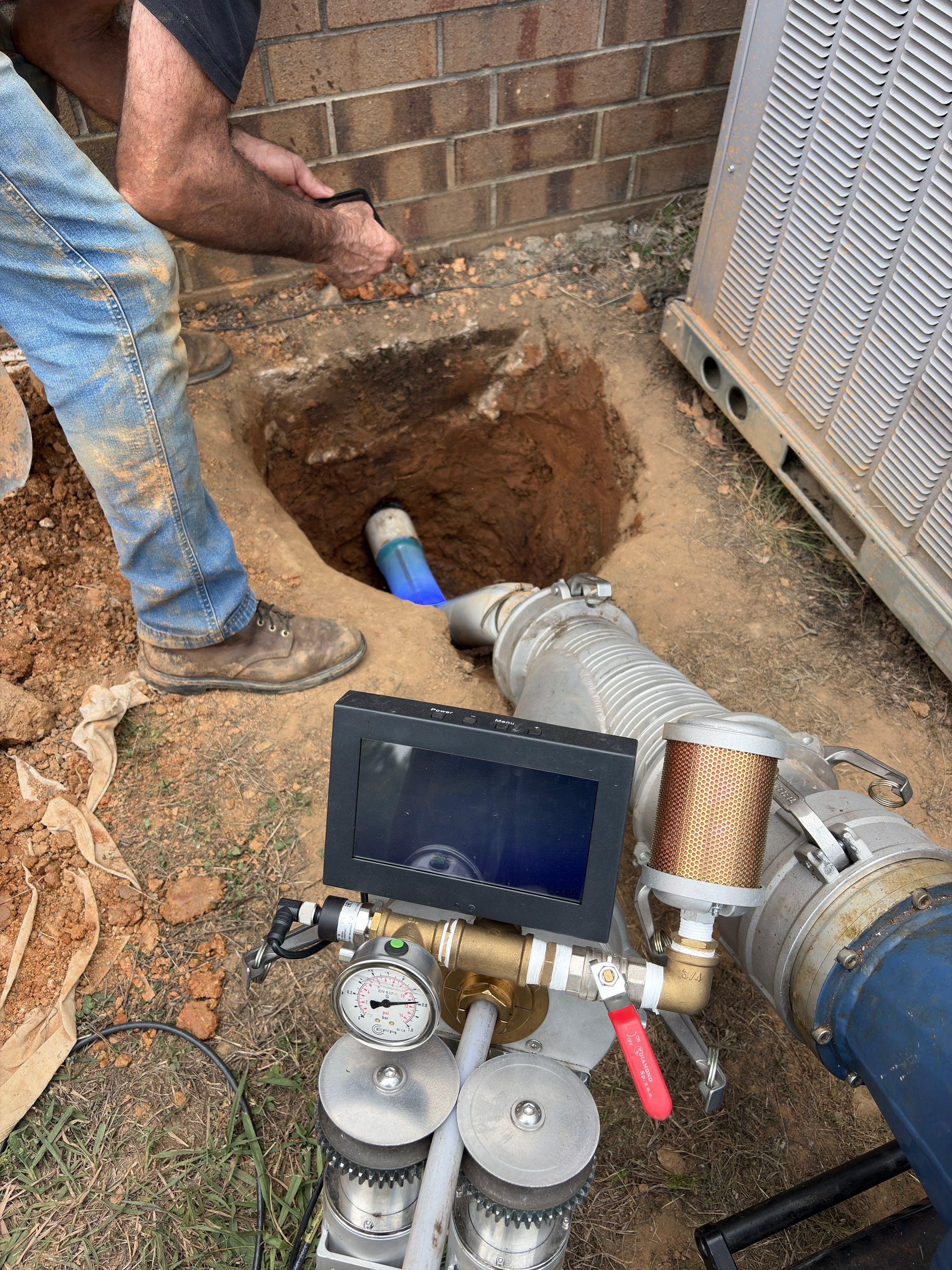 LiningWorks technician installing a trenchless Spot Repair sleeve in a sewer pipe.