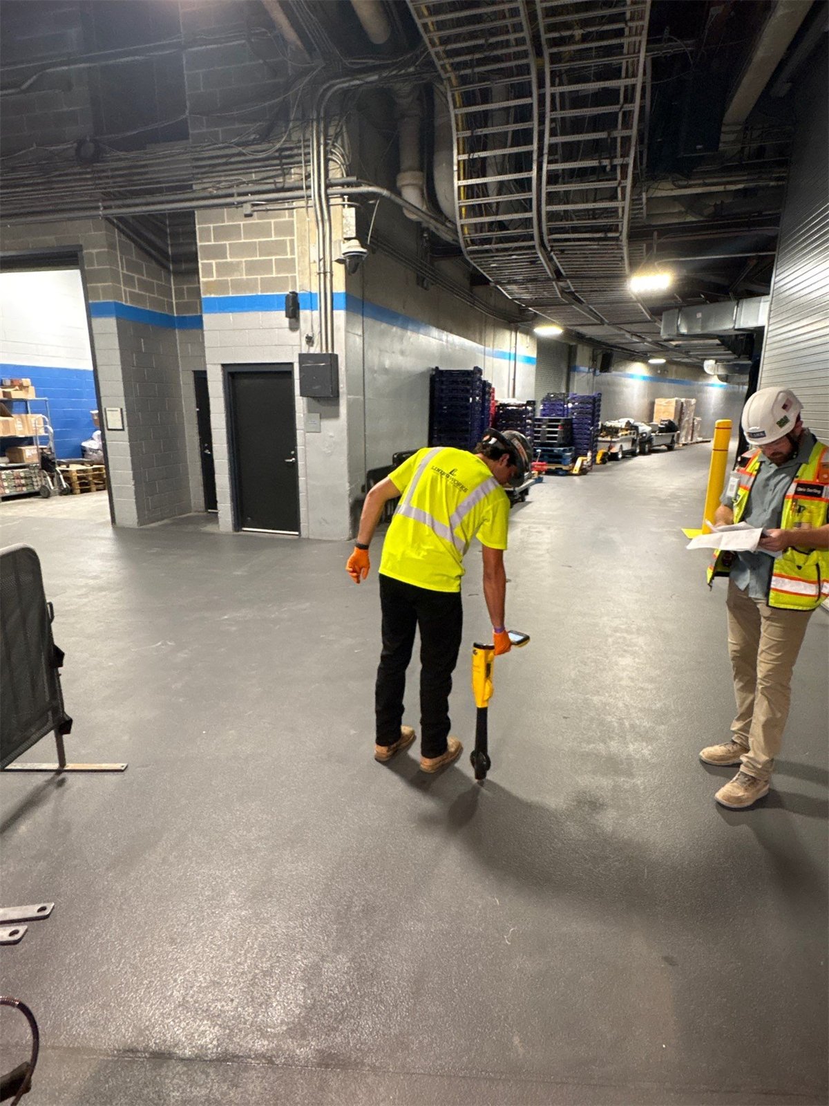 LiningWorks crew member using a pipe locating device inside a commercial building.