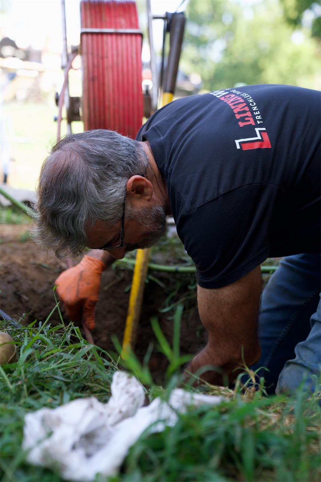 LiningWorks technician in branded gear working an excavation site in Graham, NC.
