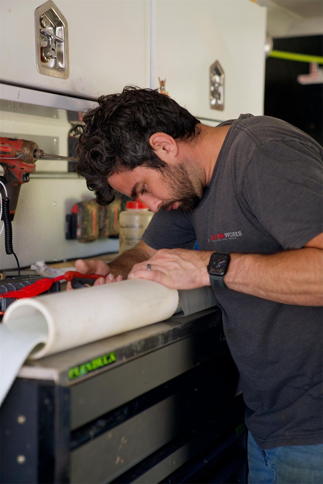 LiningWorks technician preparing a pipe liner in the service vehicle ahead of a trenchless Spot Repair.