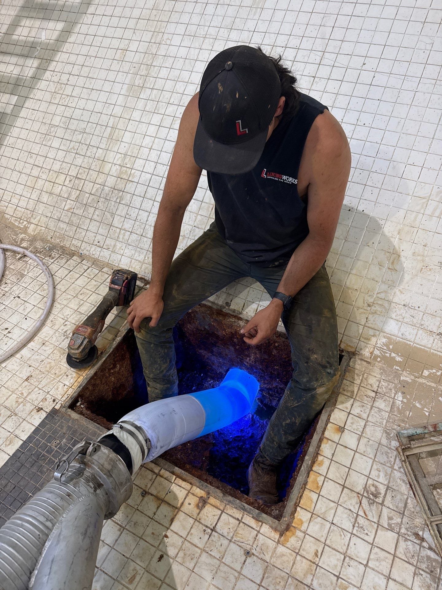 LiningWorks technician installing CIPP trenchless pipe lining using UV curing equipment.