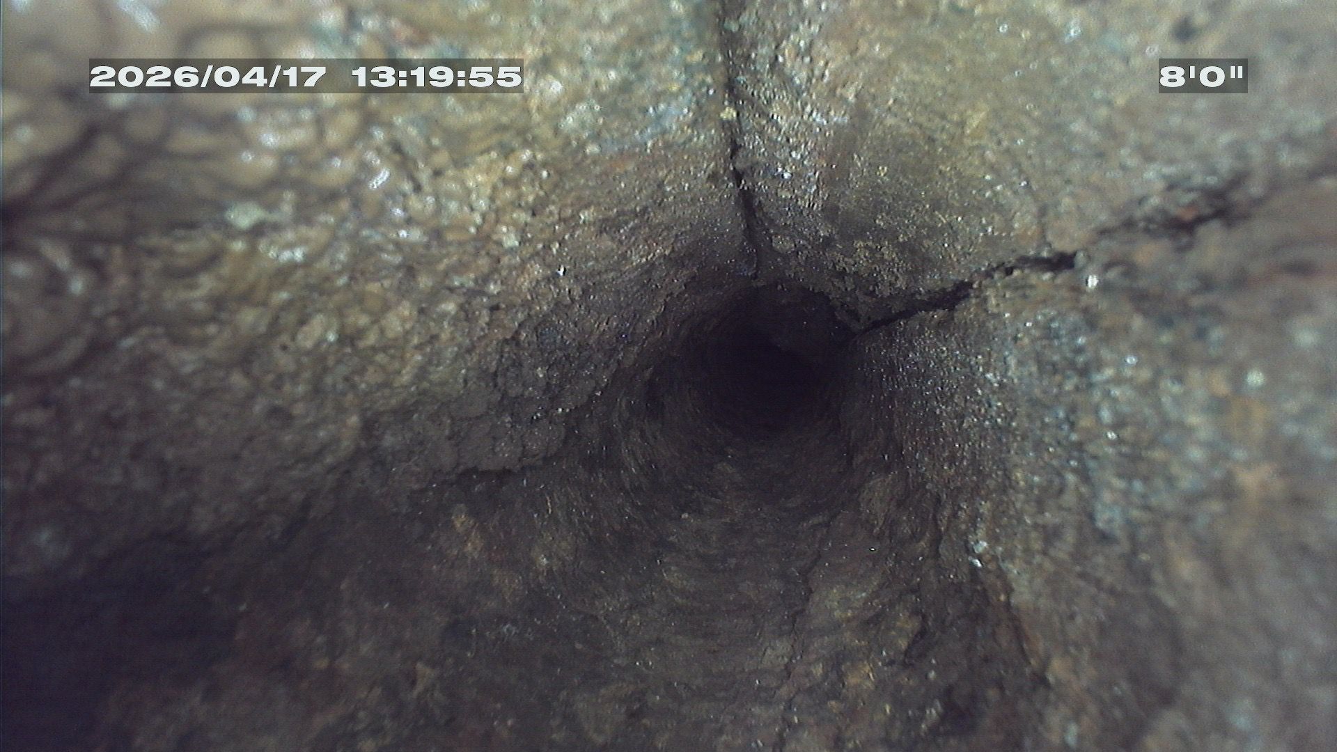 Camera inspection of a cracked commercial sewer pipe confirming conditions that indicate CIPP structural lining is needed.